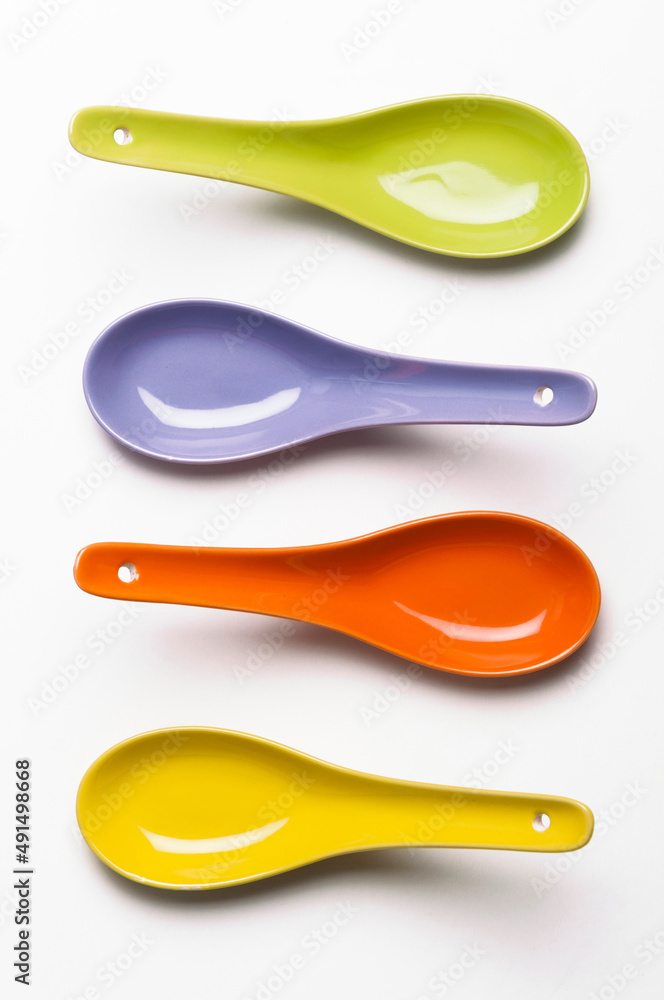 An upside down colorful soup spoons. An isolated image. An upside down colorful soup spoons. An isolated image.
