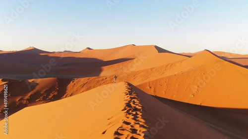 People climbing on the sand dunes in the Namib Desert, Namibia
