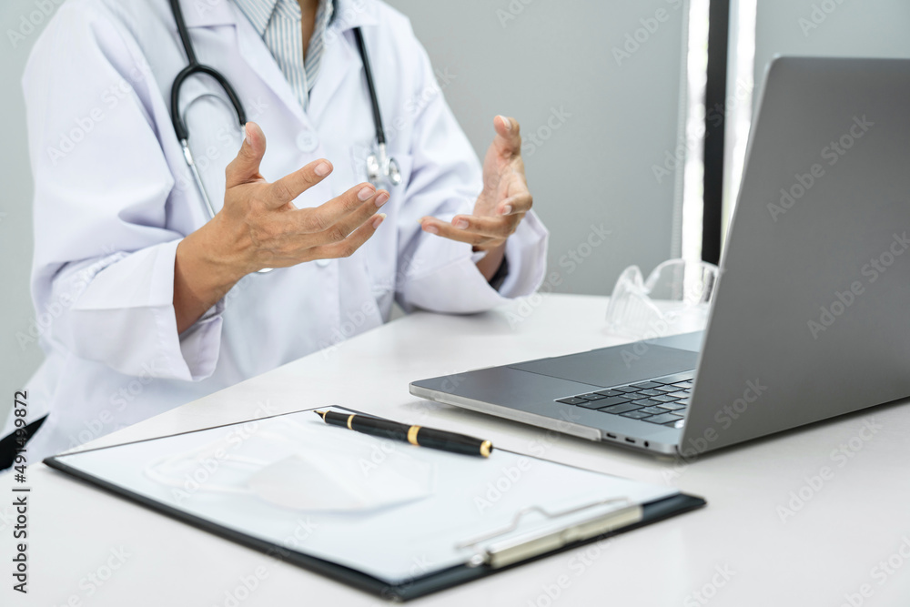 A female doctor is discussing about diagnosis of disease, symptom, and giving treatment method to a patient by video A female doctor is discussing about diagnosis of disease, symptom, and giving treatment method to a patient by video