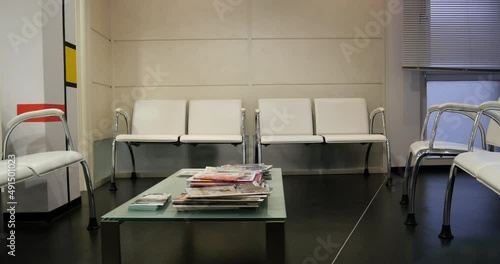 Slow tilt-up from the table with magazine in the waiting room of a Doctor's office - no patients
