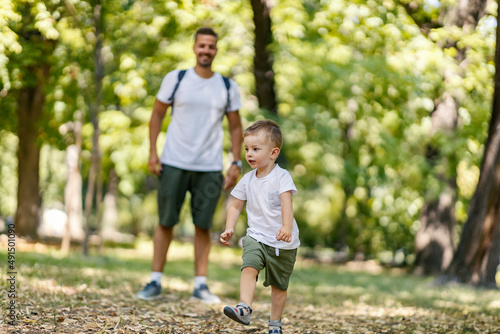 Father and son playing running away game in the nature. © dusanpetkovic1