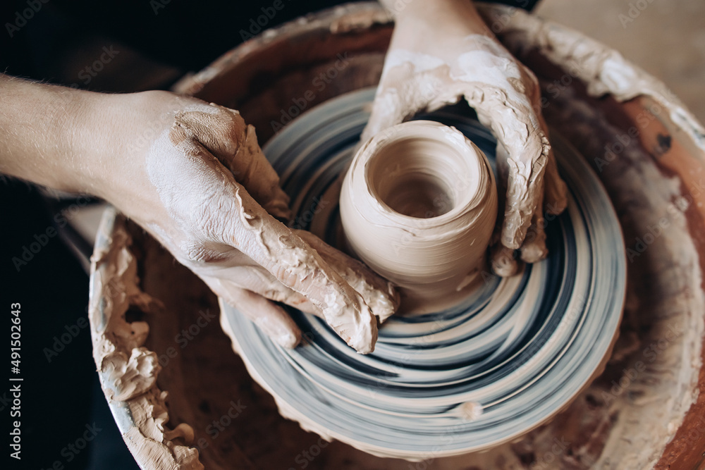 Potter makes a clay product. Close-up of hands Potter makes a clay product. Close-up of hands