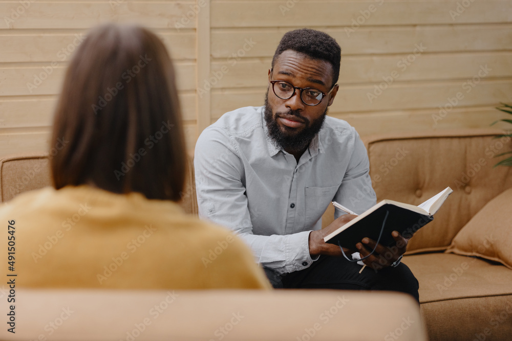 a male psychologist conducts a patient's appointment in an office or a medical center. African American male HR conducts an interview of hiring a European woman. business meeting or solving work tasks a male psychologist conducts a patient's appointment in an office or a medical center. African American male HR conducts an interview of hiring a European woman. business meeting or solving work tasks