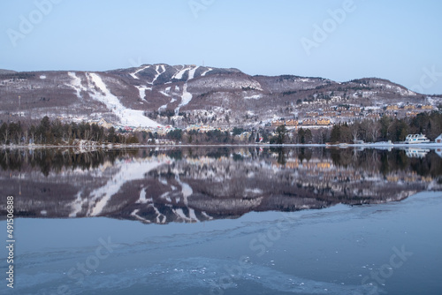 Mont-Tremblant ski slopes reflecting in a lake in winter
