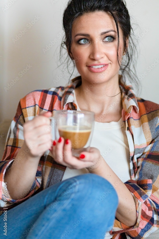 Blue eyed middle aged woman sitting with a cup of coffee Blue eyed middle aged woman sitting with a cup of coffee