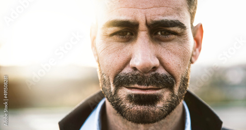 Handsome mature man portrait with intense look - Adult male looking at camera outside - People concept