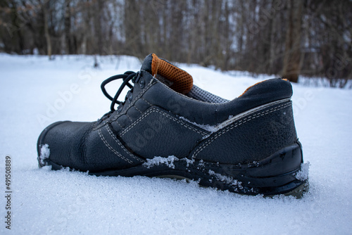 Photography man boots on snow sideview
