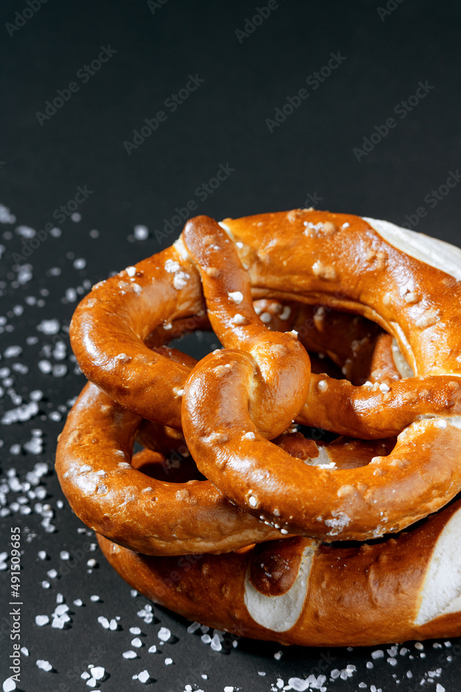 Bavarian delicious freshly baked homemade soft pretzel on dark background. Close up pretzel salt selective focus. Octoberfest. Bavarian delicious freshly baked homemade soft pretzel on dark background. Close up pretzel salt selective focus. Octoberfest.