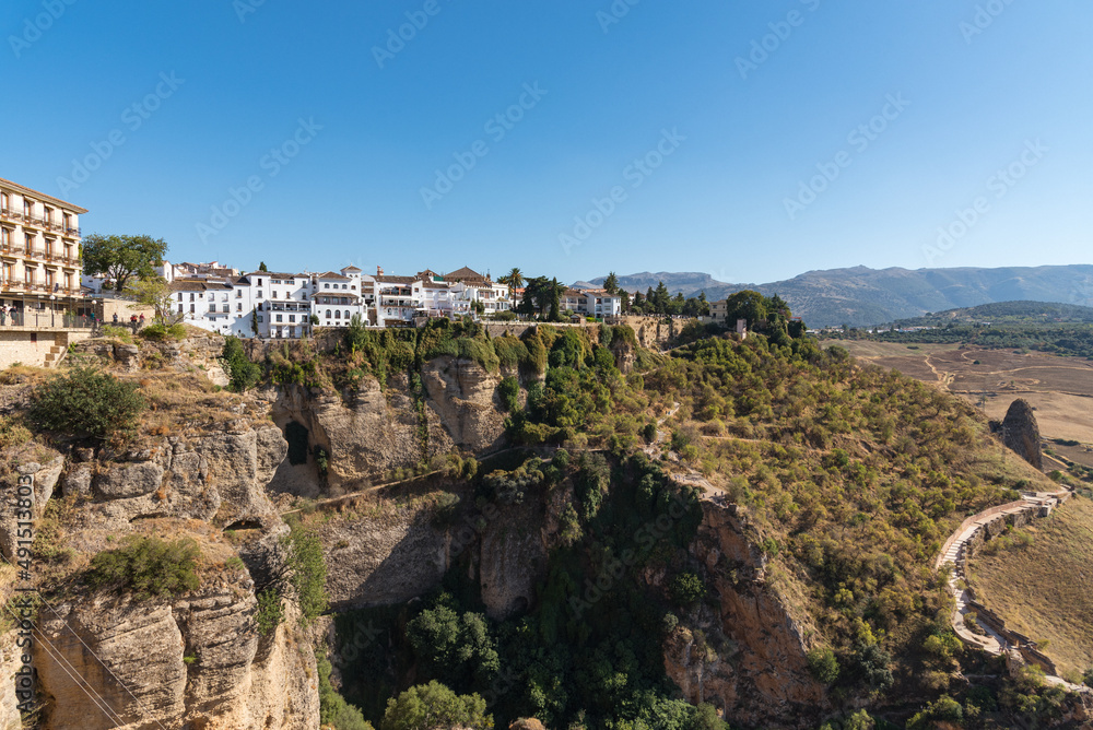The famous white village of Ronda located on El Tajo gorge from Ronda viewpoint at daylight, Malaga province, Andalusia, Spain