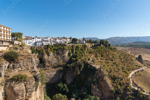 The famous white village of Ronda located on El Tajo gorge from Ronda viewpoint at daylight, Malaga province, Andalusia, Spain