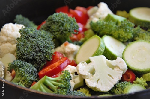 vegetables cut in a frying pan, cauliflower, broccoli, zucchini and tomato, preparation for frying