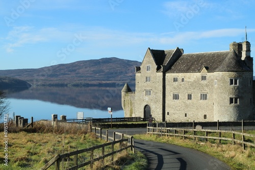 Landscape at Kilmore  County Leitrim  Ireland featuring Parke s Castle on shores of still  reflective waters of Lough Gill against backdrop of Killery Mountain