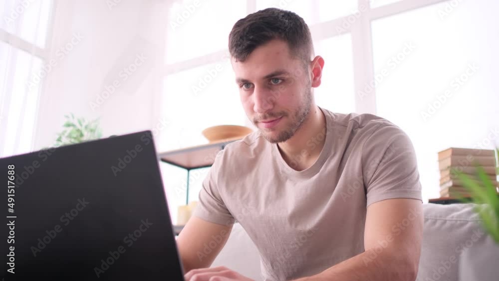 Man works from home sitting on sofa Man works from home sitting on sofa