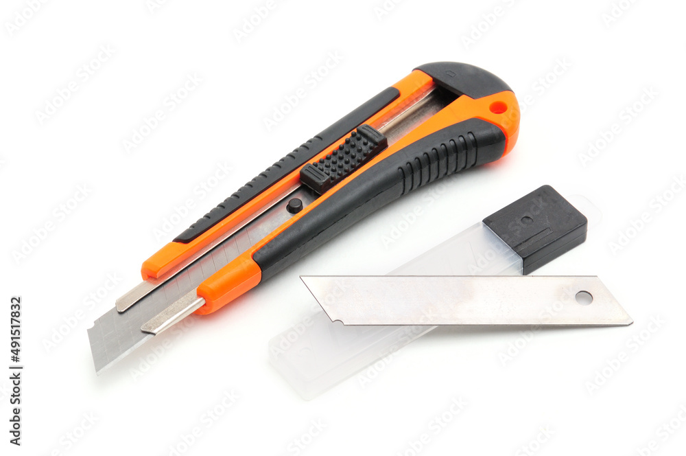 Office knife with replaceable blades on white background Office knife with replaceable blades on white background