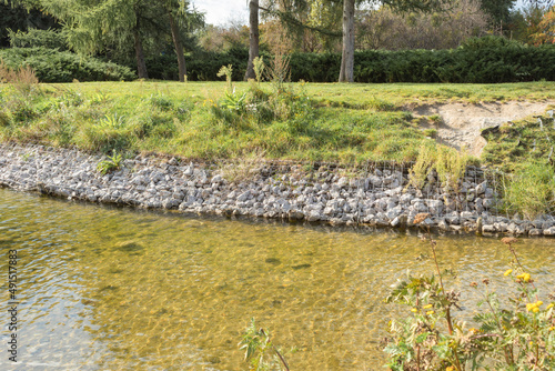Strengthening the banks of the river, mesh and stones