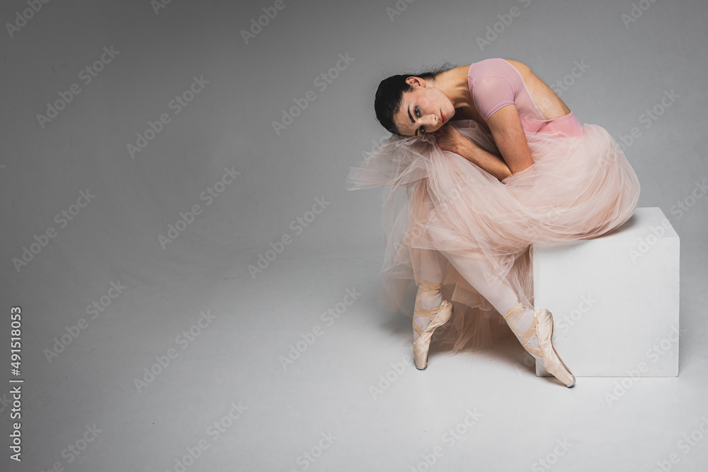 young pretty, fragile, beautiful ballerina dancing in a long pale