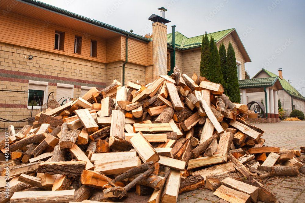 A pile of split firewood for heating the house. A pile of split firewood for heating the house.