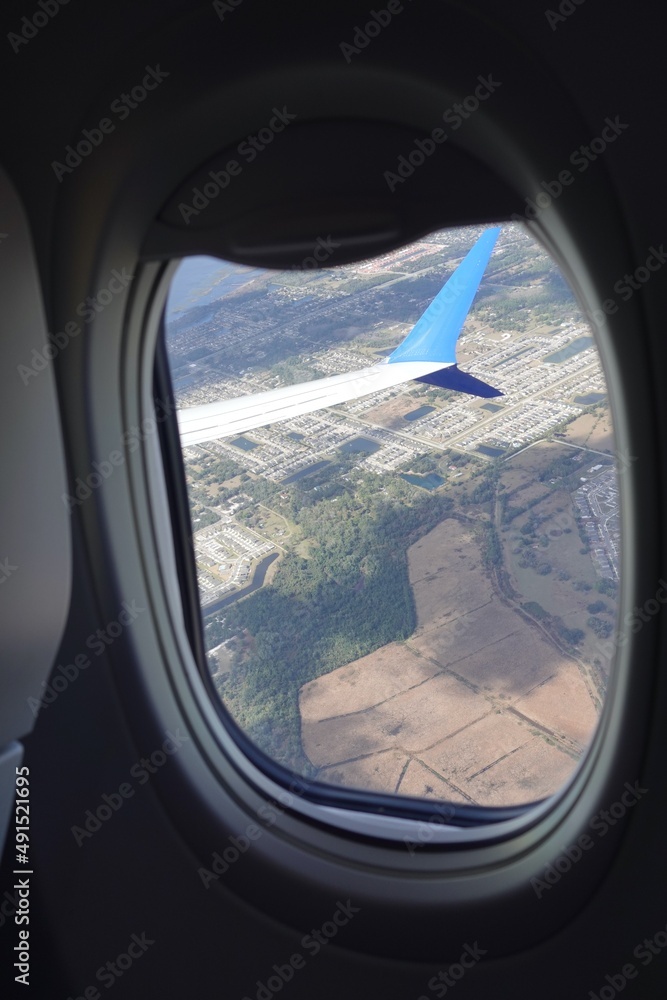 Looking outside a window on plane while flying at low altitude Looking outside a window on plane while flying at low altitude
