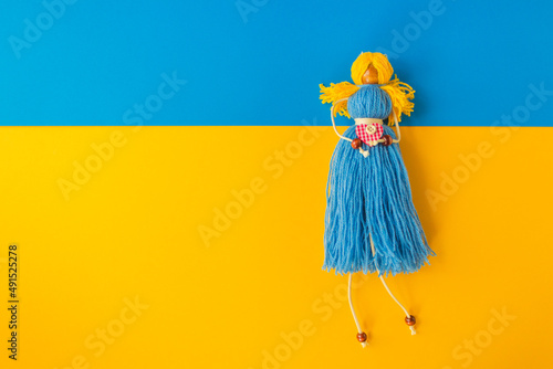 Symbol of Ukrainian nation is a handmade doll knitted from yellow and blue threads Fototapet
