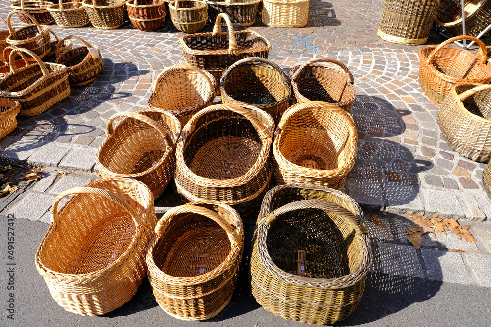 handcrafted from willow twigs, a variety of baskets sold in a market square in Germany, creative weaving from natural materials, true artisans crafting by hand, concept making artisan products handcrafted from willow twigs, a variety of baskets sold in a market square in Germany, creative weaving from natural materials, true artisans crafting by hand, concept making artisan products