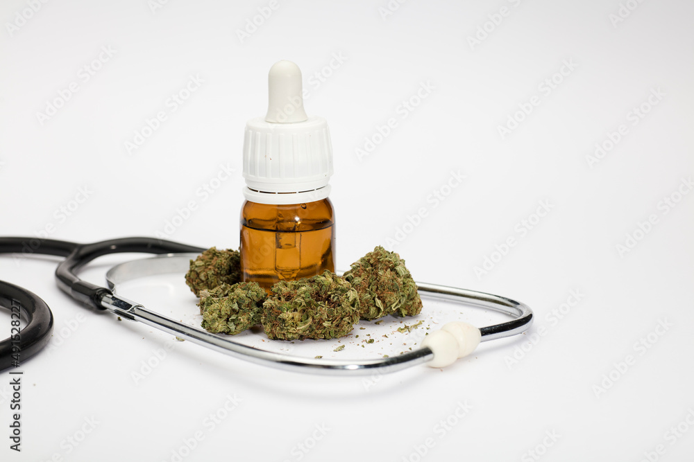 set of marijuana buds, with dosing bottle, stethoscope, white background. set of marijuana buds, with dosing bottle, stethoscope, white background.