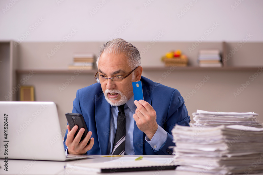 Fototapeta premium Old male boss working from home during pandemic