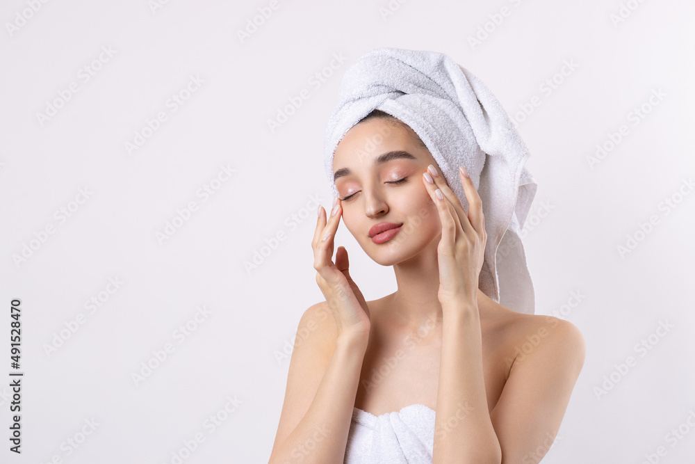 Beautiful girl with thick eyebrows and perfect skin at white background, towel on head, beauty photo. Beautiful girl with thick eyebrows and perfect skin at white background, towel on head, beauty photo.