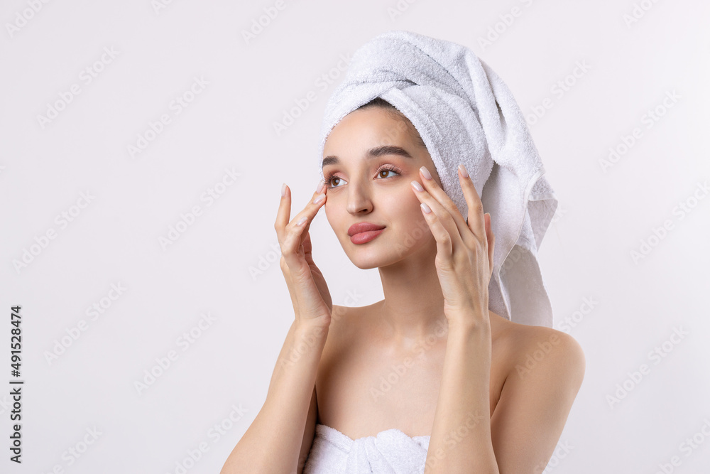Beautiful girl with thick eyebrows and perfect skin at white background, towel on head, beauty photo. Beautiful girl with thick eyebrows and perfect skin at white background, towel on head, beauty photo.