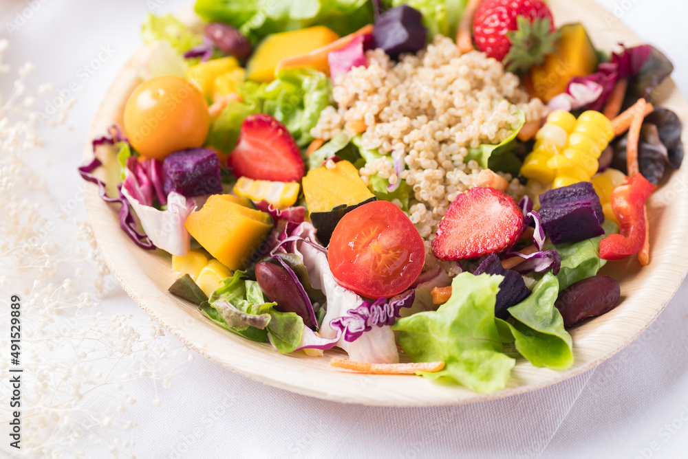 Fresh mixed fruits and vegetables salad in natural plate on white background, Healthy vegan food Fresh mixed fruits and vegetables salad in natural plate on white background, Healthy vegan food
