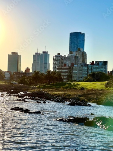 Verano en Uruguay, puesta de sol en playa de Montevideo, Costas uruguayas con rambla. Paisajes Uruguay, Edificios con vista al mar y cielo azul photo