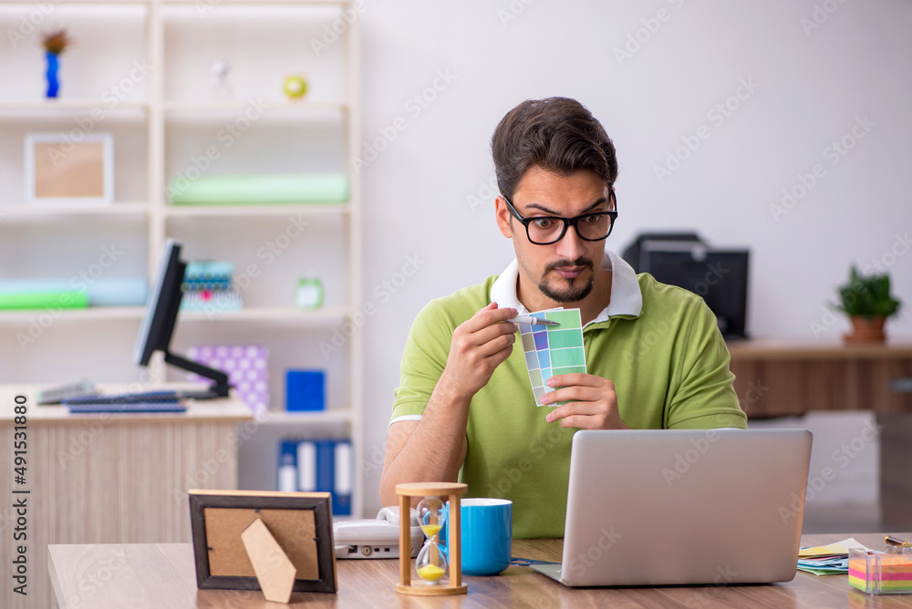 Young male designer working in the office Young male designer working in the office