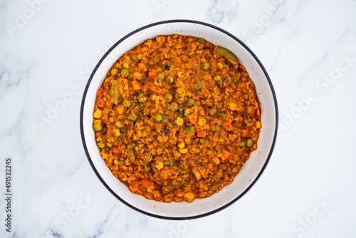 vegan red lentil dahl with mixed veggies, healthy plant-based food photo