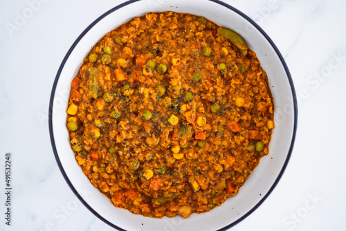 vegan red lentil dahl with mixed veggies, healthy plant-based food photo