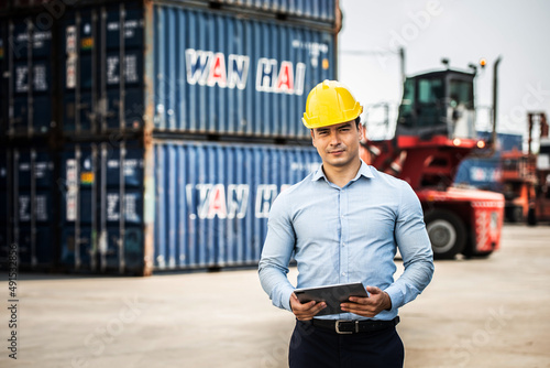 Caucasian worker use smartphone and tablet about business working at the port for transfer products.