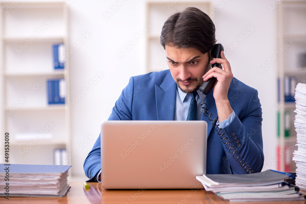 Fototapeta premium Young businessman employee working in the office