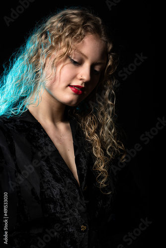 Glamour studio Portrait of a 21 year old white blonde woman with curling hair