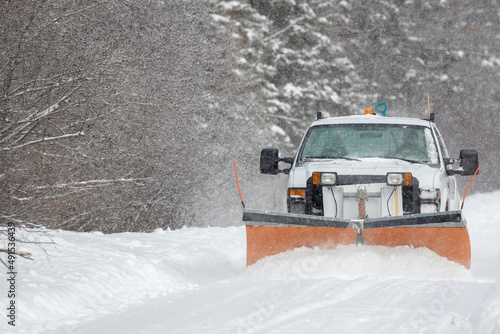 Truck plowing a road during a winter storm in Ontario