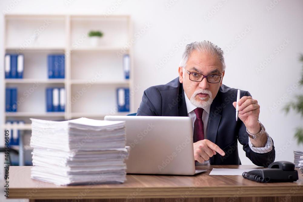 Old male employee and too much work in the office Old male employee and too much work in the office
