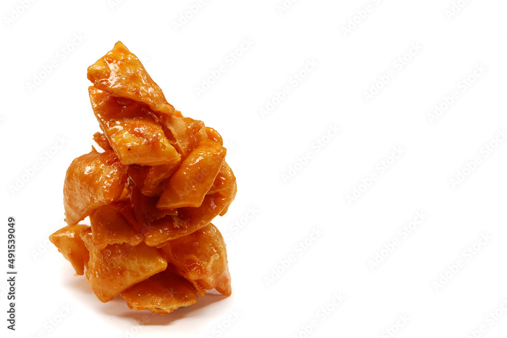 dulce de muéganos poblanos, puffed squares of flour covered in honey, typical Mexican sweet, on white background with space for text dulce de muéganos poblanos, puffed squares of flour covered in honey, typical Mexican sweet, on white background with space for text