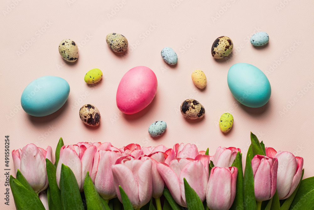easter greeting card concept. bouquet of pink tulips with set of varios pastel colorful easter egss on pink backround. Easter background. top view with copyspace easter greeting card concept. bouquet of pink tulips with set of varios pastel colorful easter egss on pink backround. Easter background. top view with copyspace