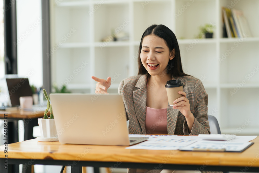 Asian business woman talking to her colleagues about plan in video conference. Multiethnic business team using computer for a online meeting in video call. Group of people smart working from home.