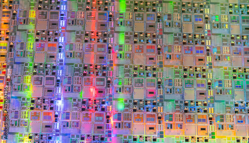 Macro of silicon wafer semiconductor with neon color, integrated circuits to manufacture CPU and GPU © xiaoliangge