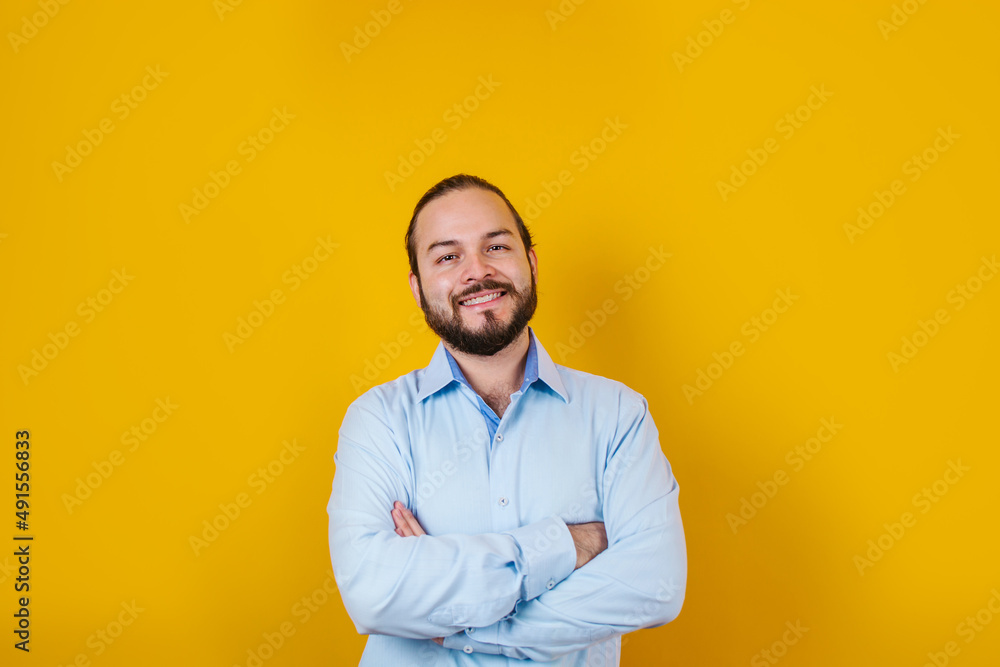young latin bearded business man wearing formal clothes smiling at camera in yellow background in Mexico Latin America young latin bearded business man wearing formal clothes smiling at camera in yellow background in Mexico Latin America
