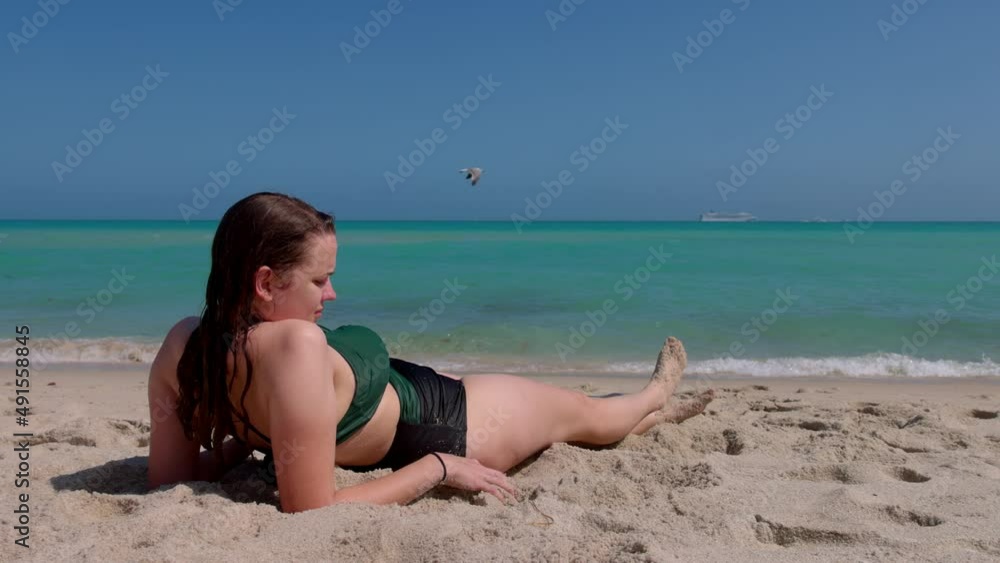 Pretty girl relaxing at the beach on her summer vacation in Florida - travel photography Pretty girl relaxing at the beach on her summer vacation in Florida - travel photography