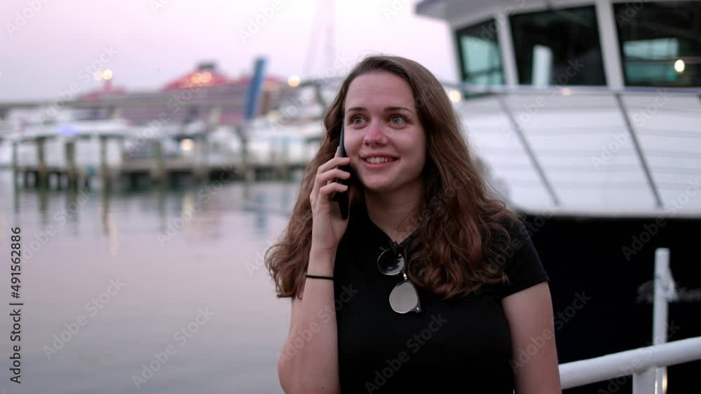 Young woman taking a phone call at the Port of Miami - travel photography Young woman taking a phone call at the Port of Miami - travel photography