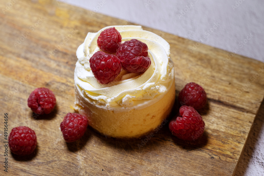 cheesecake with raspberries on wood table cheesecake with raspberries on wood table