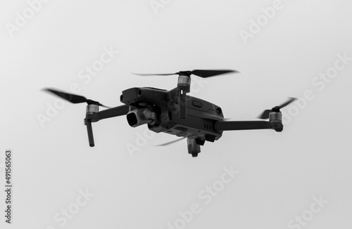 Fototapeta Naklejka Na Ścianę i Meble -  Drone in flight against a cloudy sky.