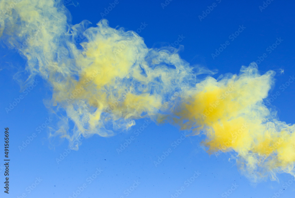 Yellow smoke on a blue background.