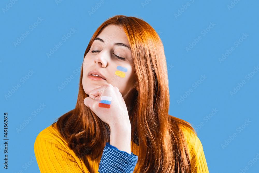 Girl receives a punch in the face from the hand with Russian flag