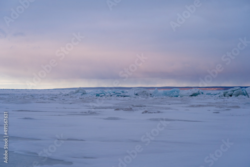 Blue Ice Chunks on Lake Michigan - Frozen Lake with snow, beautiful colorful sky, and clouds in the background